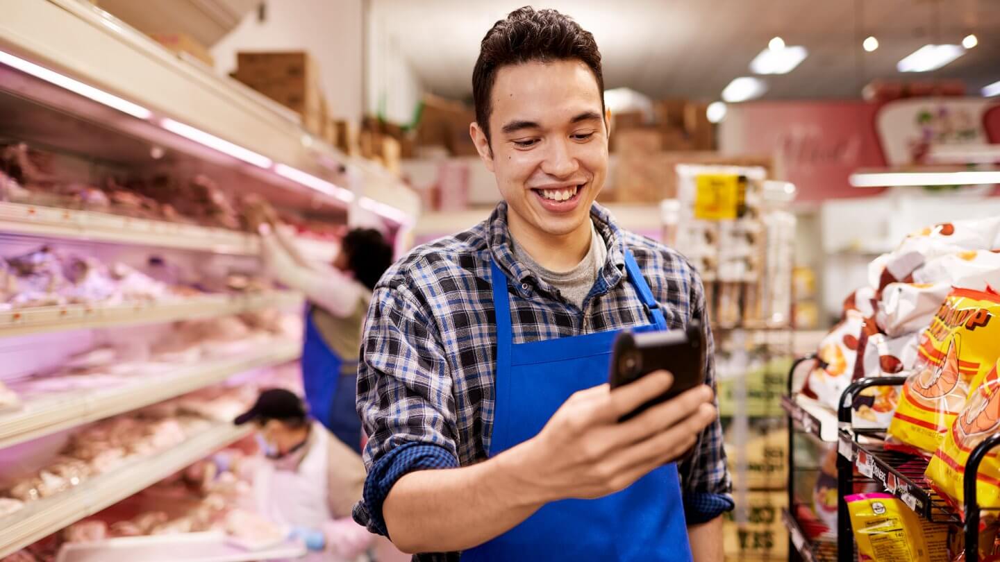 Happy worker looking at phone DailyPay