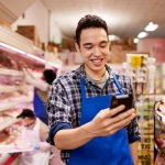 Happy worker looking at phone DailyPay