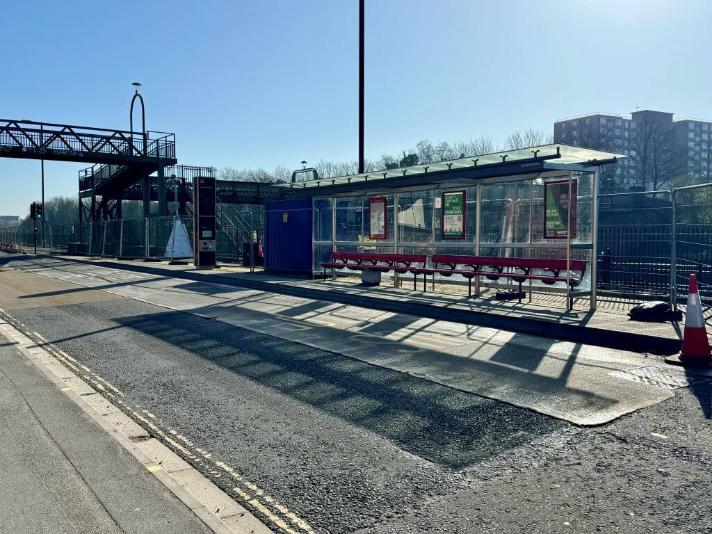 Bus stop by the side of the road for testing AI vision language model