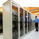 Technician preparing check list in server room.